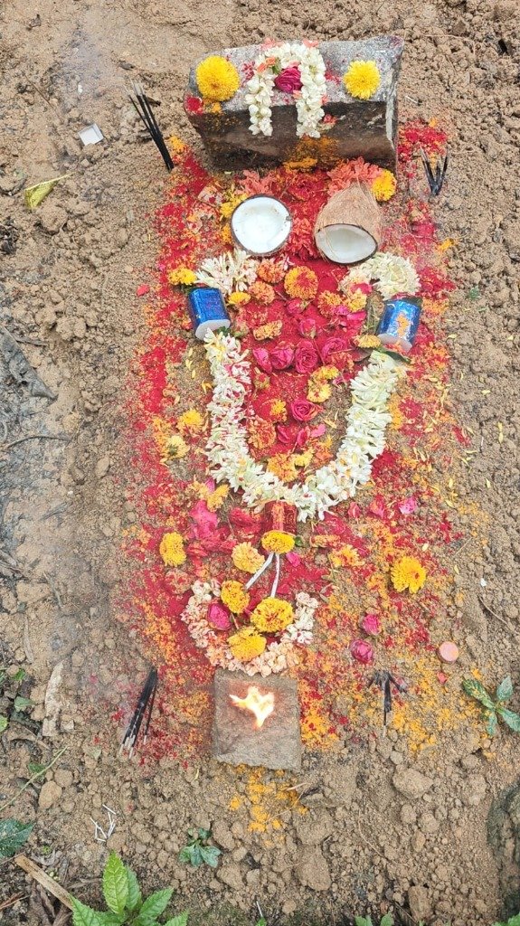 Elaborately decorated pet grave with marigold garlands, roses, coconut and diya — premium burial service Bengaluru